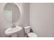 Small bathroom with pedestal sink, toilet, and vanity mirror at 2370 W 167Th Ln, Broomfield, CO 80023