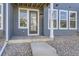 Modern front door entrance with gray siding and stone accents at 2370 W 167Th Ln, Broomfield, CO 80023