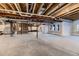Unfinished basement space showing exposed beams, pipes, windows, and framing at 8868 Geyser Peak Way, Parker, CO 80138