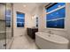 Luxurious bathroom with soaking tub, walk-in shower, and dual vanity at 8868 Geyser Peak Way, Parker, CO 80138