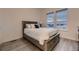 Comfortable bedroom showcasing a cozy bed, wood floors, and bright windows with natural light at 8868 Geyser Peak Way, Parker, CO 80138
