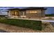 Beautiful house featuring stone and wood accents, a well-manicured lawn, and modern landscaping at 8868 Geyser Peak Way, Parker, CO 80138