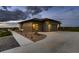 Modern home exterior featuring a two-car garage, sleek design, and manicured landscaping at 8868 Geyser Peak Way, Parker, CO 80138