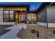Modern home featuring a stone facade, wood accents, and a stylish, multi-pane front door at 8868 Geyser Peak Way, Parker, CO 80138