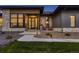 Home's front entrance showcases modern architecture with stone accents and inviting walkway at 8868 Geyser Peak Way, Parker, CO 80138