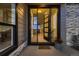 Inviting front entrance with glass door, stylish design and potted flowers at 8868 Geyser Peak Way, Parker, CO 80138