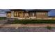 Stunning home exterior with manicured lawn, stone accents, and modern design elements at 8868 Geyser Peak Way, Parker, CO 80138