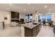Spacious open living area featuring modern furnishings, a fireplace, and large windows at 8868 Geyser Peak Way, Parker, CO 80138