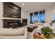 Contemporary living room featuring a fireplace, large windows, and comfortable seating at 8868 Geyser Peak Way, Parker, CO 80138