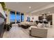 Open-concept living room with expansive windows and sleek, modern furnishings at 8868 Geyser Peak Way, Parker, CO 80138