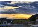 Neighborhood view featuring a basketball court, pool, and stunning sunset over the mountains at 8868 Geyser Peak Way, Parker, CO 80138