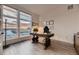 Bright office space with modern decor, a unique desk, and large windows overlooking a scenic view at 8868 Geyser Peak Way, Parker, CO 80138