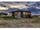 Back exterior of home with two-car garage, fenced backyard, and open fields at 8868 Geyser Peak Way, Parker, CO 80138