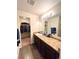 A bathroom features a long vanity with dual mirrors and a walk in closet at 47373 Lily Ave, Bennett, CO 80102