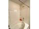 This bathroom features a white tub and shower with built-in shelving at 47373 Lily Ave, Bennett, CO 80102