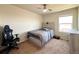 This bedroom offers carpet, a ceiling fan and a large window for natural light at 47373 Lily Ave, Bennett, CO 80102