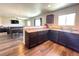Open-concept kitchen with wooden cabinets, stainless steel appliances, and a view into the living area at 47373 Lily Ave, Bennett, CO 80102