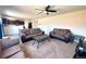 Spacious living room with comfortable seating, a ceiling fan, and a view of the kitchen area at 47373 Lily Ave, Bennett, CO 80102