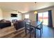 Open concept living room and dining area featuring hardwood floors and sliding glass doors at 47373 Lily Ave, Bennett, CO 80102