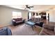 Bright and airy living room with a ceiling fan, comfortable seating, and a view of the kitchen at 47373 Lily Ave, Bennett, CO 80102