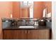 Powder room with designer wallpaper, a framed mirror and stylish vanity at 1690 Bassett St # 6, Denver, CO 80202