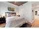 Cozy bedroom with natural light, hardwood floors, and a decorative painting at 1690 Bassett St # 6, Denver, CO 80202