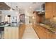 Open kitchen featuring sleek wood cabinetry, granite countertops, stainless steel appliances, and island seating at 1690 Bassett St # 6, Denver, CO 80202