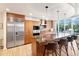 Gourmet kitchen with granite countertops, stainless steel appliances, and a breakfast bar seating four at 1690 Bassett St # 6, Denver, CO 80202