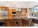 Chef's kitchen showcasing a large island with granite countertops, pendant lighting and stainless appliances at 1690 Bassett St # 6, Denver, CO 80202