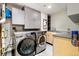 Laundry room equipped with modern washer, dryer, cabinets and a sink at 1690 Bassett St # 6, Denver, CO 80202