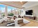 Sun-drenched living room featuring large windows, neutral furniture, and a modern entertainment center at 1690 Bassett St # 6, Denver, CO 80202