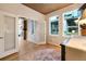 Living room featuring wood floors, tall windows, and open doorways to a dining area at 1690 Bassett St # 6, Denver, CO 80202