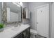 Bathroom featuring a vanity with a white countertop, decorative mirror, and bathtub/shower combination at 10177 E Peakview Ave, Englewood, CO 80111