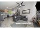 Open living room featuring high vaulted ceilings, gray walls and flooring, and a cozy sectional sofa at 10177 E Peakview Ave, Englewood, CO 80111