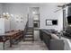 Living room with open floorplan features stairs leading to downstairs and upstairs and flows to dining area at 10177 E Peakview Ave, Englewood, CO 80111