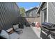 Outdoor patio area with grill, cushioned seating, and a fire pit for entertaining guests at 10177 E Peakview Ave, Englewood, CO 80111