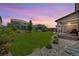 Expansive backyard with lush green lawn, perfect for outdoor entertaining with a covered patio at 16268 Mount Silverheels Way, Broomfield, CO 80023