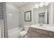 Modern bathroom features a sleek vanity, updated fixtures, and a stylish shower-tub combination at 16268 Mount Silverheels Way, Broomfield, CO 80023