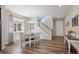 Elegant dining area featuring hardwood floors, a chandelier, and a staircase, perfect for entertaining at 16268 Mount Silverheels Way, Broomfield, CO 80023