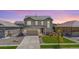 Beautiful two-story home featuring a well-manicured lawn, a two car garage, and lovely landscaping at 16268 Mount Silverheels Way, Broomfield, CO 80023