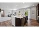 Open concept kitchen with a center island, stainless steel appliances, and seamless connection to the living room at 16268 Mount Silverheels Way, Broomfield, CO 80023