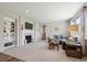 Inviting living room featuring a fireplace, built-in shelving, and a comfortable seating arrangement at 16268 Mount Silverheels Way, Broomfield, CO 80023