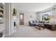 Bright living room features a fireplace, built-in shelving and a large window with an outside view at 16268 Mount Silverheels Way, Broomfield, CO 80023