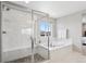 Luxurious main bathroom featuring a stand-alone tub, a walk-in shower, and a bright window view at 16268 Mount Silverheels Way, Broomfield, CO 80023