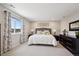 Bright main bedroom offering neutral tones, plush carpet, and a view from the window at 16268 Mount Silverheels Way, Broomfield, CO 80023