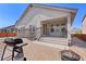 Backyard showing a patio, outdoor grill, brick pavers and a covered patio at 24447 E Ada Ave, Aurora, CO 80018