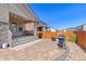 Covered back patio with brick pavers, a fire pit, and outdoor grill at 24447 E Ada Ave, Aurora, CO 80018