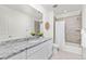 Well-lit bathroom with granite countertops, bathtub, shower and decorative plants at 24447 E Ada Ave, Aurora, CO 80018