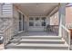 Cozy covered patio with seating, lighting, and views of the backyard at 24447 E Ada Ave, Aurora, CO 80018