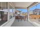 Covered patio featuring outdoor furniture, wood floors, and a view of the backyard at 24447 E Ada Ave, Aurora, CO 80018